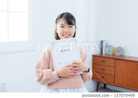 Family looking at report cards in the living room Family looking at report cards in the living room 137070499
