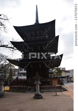 Takayama City, Gifu Prefecture, Japan - Hida Kokubunji Temple's three-story pagoda and surrounding townscape during the Takayama Spring Festival Takayama City, Gifu Prefecture, Japan - Hida Kokubunji Temple's three-story pagoda and surrounding townscape during the Takayama Spring Festival 137070872