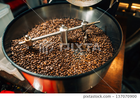 reshly roasted coffee beans mixing in a commercial coffee roaster machine. 137070900