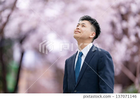 Freshman young man in suit looking up Freshman young man in suit looking up 137071146
