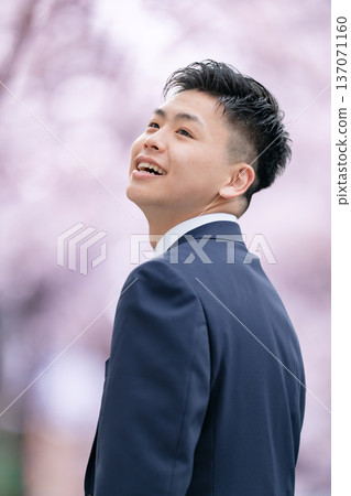 Freshman young man in suit looking up Freshman young man in suit looking up 137071160