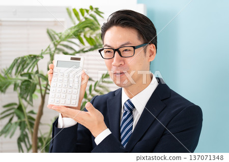 A man with a calculator A man with a calculator 137071348