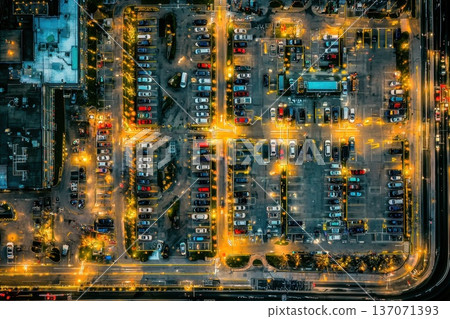 Aerial View of a Brightly Lit Urban Parking Lot Divided Into Sections at Night Aerial View of a Brightly Lit Urban Parking Lot Divided Into Sections at Night 137071393
