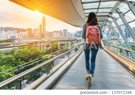 Professional Woman Walking in Urban Environment with Cityscape at Sunrise 137071596