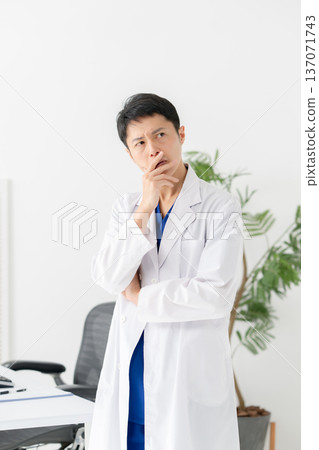 Medical white coat man thinking Medical white coat man thinking 137071743
