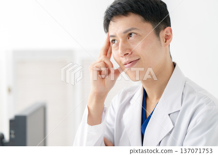Medical white coat man thinking Medical white coat man thinking 137071753