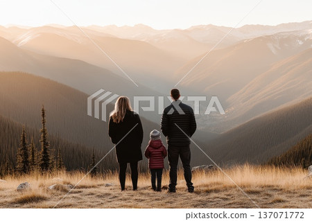 Family Standing on Mountain Top Overlooking Scenic Valley at Sunset in Tranquil Nature Family Standing on Mountain Top Overlooking Scenic Valley at Sunset in Tranquil Nature 137071772