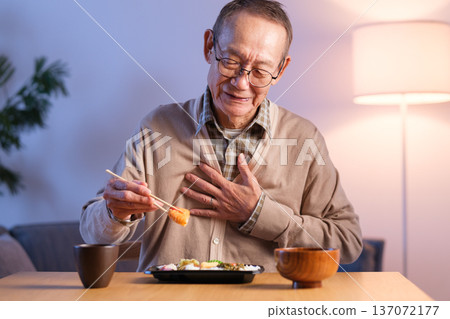 Senior man eating lunch, stomach upset 137072177