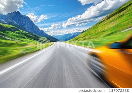 Bright Orange Roadster Accelerating on Scenic Road Through Lush Green Landscape Bright Orange Roadster Accelerating on Scenic Road Through Lush Green Landscape 137072288