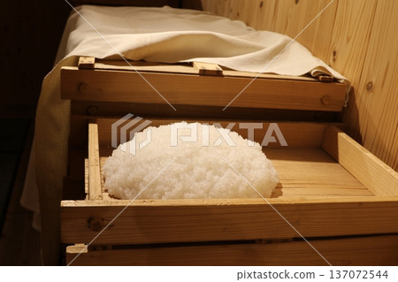 Steamed rice for sake brewing. Steaming process of sake rice spread out in a wooden box ① Steamed rice for sake brewing. Steaming process of sake rice spread out in a wooden box ① 137072544