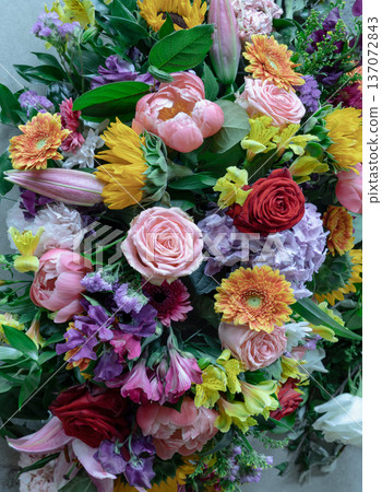 A rich tapestry of color, this mixed arrangement features a curated selection of red and pink roses, a soft lilac hydrangea, and bold orange gerbera daisies, balanced by delicate carnations and A rich tapestry of color, this mixed arrangement features a curated selection of red and pink roses, a soft lilac hydrangea, and bold orange gerbera daisies, balanced by delicate carnations and 137072843