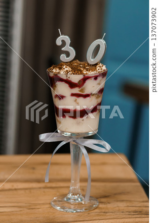 Elegant 30th Birthday Dessert Trifle in Glass Cup with Silver Number Candles and Chocolate Dusting Elegant 30th Birthday Dessert Trifle in Glass Cup with Silver Number Candles and Chocolate Dusting 137073902