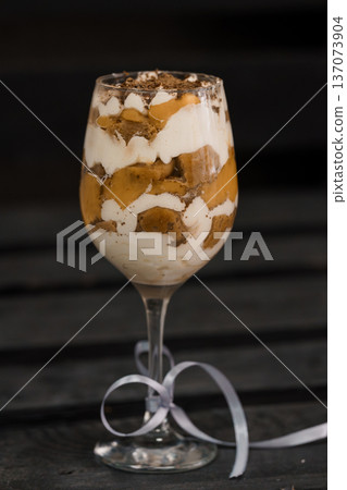 Elegant Chocolate Mousse Dessert in a Wine Glass with Cream Layers and Cocoa Powder Topping Elegant Chocolate Mousse Dessert in a Wine Glass with Cream Layers and Cocoa Powder Topping 137073904