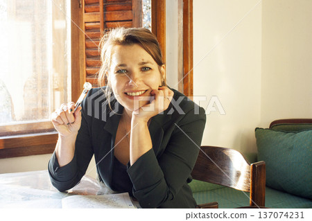 young cheerful woman in business suit sitting at the table, lifestyle people concept young cheerful woman in business suit sitting at the table, lifestyle people concept 137074231