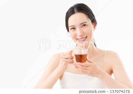 Healthy image of a woman drinking tea on a white background Healthy image of a woman drinking tea on a white background 137074278