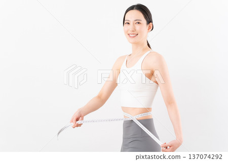 Beauty image of a woman dieting on a white background Beauty image of a woman dieting on a white background 137074292