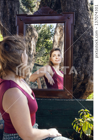 young pretty woman in garden with big mirror, lifestyle people concept young pretty woman in garden with big mirror, lifestyle people concept 137074301