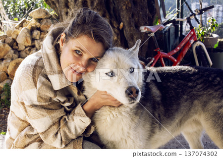 young pretty woman with husky dog outside, lifestyle people concept young pretty woman with husky dog outside, lifestyle people concept 137074302