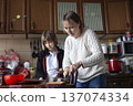 big family having dinner with mother working on laptop, lifestyle people concept 137074334
