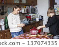 big family having dinner with mother working on laptop, lifestyle people concept 137074335