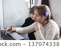 mother with daughter at home working on laptop, lifestyle people concept 137074338
