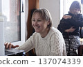 mother with daughter at home working on laptop, lifestyle people concept 137074339