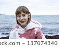 little cute blond girl curious smiling playing outside on sea, lifestyle people concept 137074340