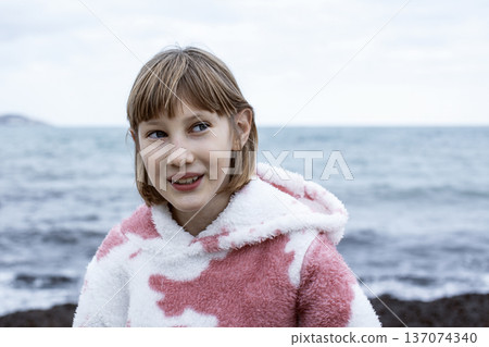 little cute blond girl curious smiling playing outside on sea, lifestyle people concept 137074340