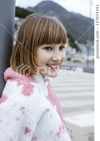 little cute blond girl curious smiling playing outside on sea, lifestyle people concept 137074341