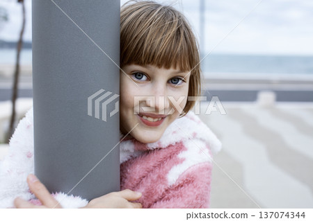 little cute blond girl curious smiling playing outside on sea, lifestyle people concept 137074344