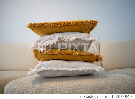 Stack of decorative pillows on sofa in cozy Scandinavian living room Stack of decorative pillows on sofa in cozy Scandinavian living room 137074949