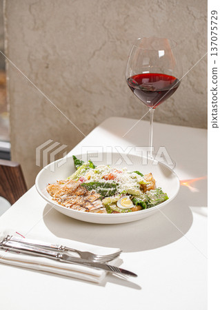 Caesar salad with grilled chicken and wine Caesar salad with grilled chicken and wine 137075729