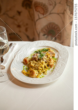 Pasta with shrimp in creamy pesto sauce Pasta with shrimp in creamy pesto sauce 137075735