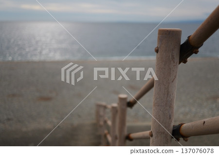 Wooden railing leading to the coastline 137076078