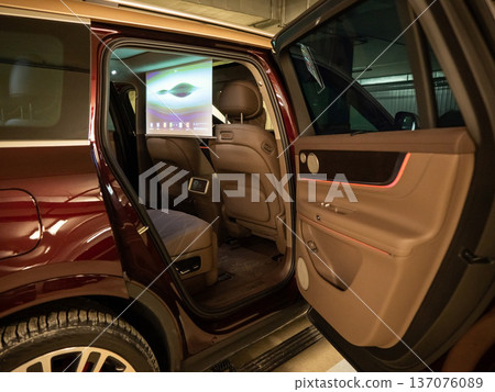 A projector opens in the car's interior for passengers to watch movies. A projector opens in the car's interior for passengers to watch movies. 137076089