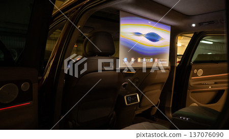 A projector opens in the car's interior for passengers to watch movies. A projector opens in the car's interior for passengers to watch movies. 137076090