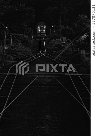 Night view of the Hakodate Main Line in Hokkaido: A junction illuminated by train headlights 137076131