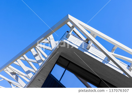 Abstract architecture background displays a corner of white metal roof framework Abstract architecture background displays a corner of white metal roof framework 137076307
