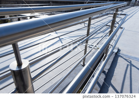 Perspective view of a polished stainless steel railing 137076324