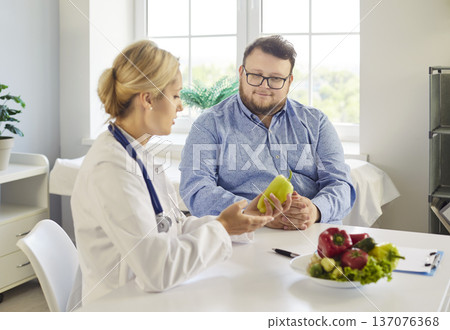 Doctor counseling patient on nutrition and weight management with vegetables Doctor counseling patient on nutrition and weight management with vegetables 137076368