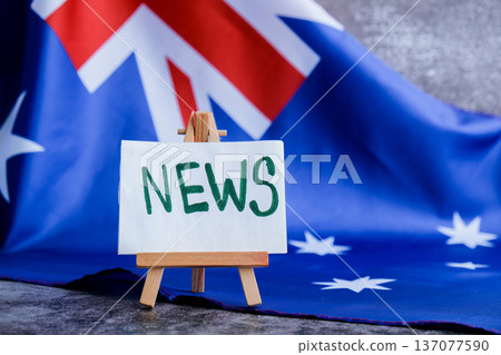 Flag-themed board with NEWS text for media headlines. Patriotic mockup with text NEWS Vibrant Australian flag background trending for current affairs content. Concept of national reporting Flag-themed board with NEWS text for media headlines. Patriotic mockup with text NEWS Vibrant Australian flag background trending for current affairs content. Concept of national reporting 137077590