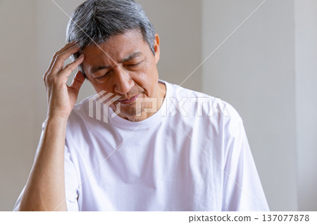 Senior man holding his head Senior man holding his head 137077878