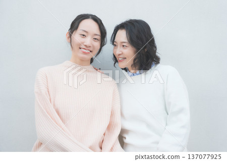 Retro-inspired portrait of a close mother and daughter Retro-inspired portrait of a close mother and daughter 137077925