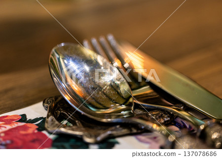 A close-up of exquisite silverware in an elegant restaurant A close-up of exquisite silverware in an elegant restaurant 137078686