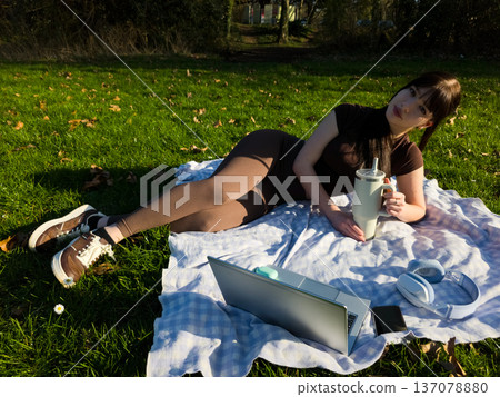 Young woman working and studying outdoors in park with laptop, remote lifestyle and online education concept Young woman working and studying outdoors in park with laptop, remote lifestyle and online education concept 137078880