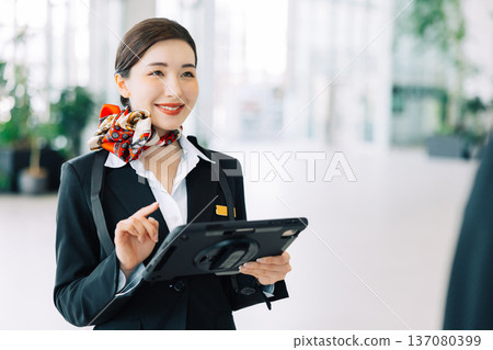 Airport ground staff holding a tablet (Photo courtesy of Kobe Airport (UKB)) Airport ground staff holding a tablet (Photo courtesy of Kobe Airport (UKB)) 137080399