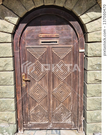 The doors are a true masterpiece of carpentry. They do not just close the entrance, but become a separate architectural accent that fits perfectly into the stonework of Old Nessebar. The geometric car 137080470