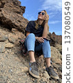 A happy tourist walks in a park near a volcano on the island of Tenerife, Spain 137080549