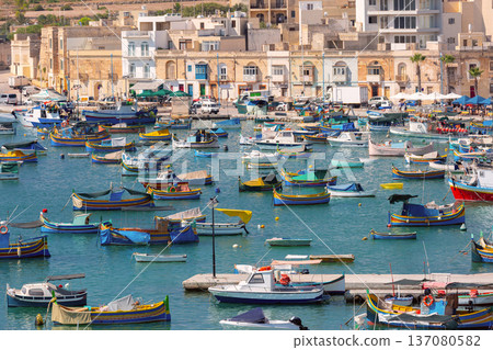 Traditional luzzu fishing boats in Marsaxlokk harbor Malta 137080582