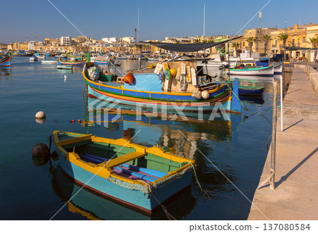 Traditional luzzu fishing boats in Marsaxlokk harbor Malta Traditional luzzu fishing boats in Marsaxlokk harbor Malta 137080584